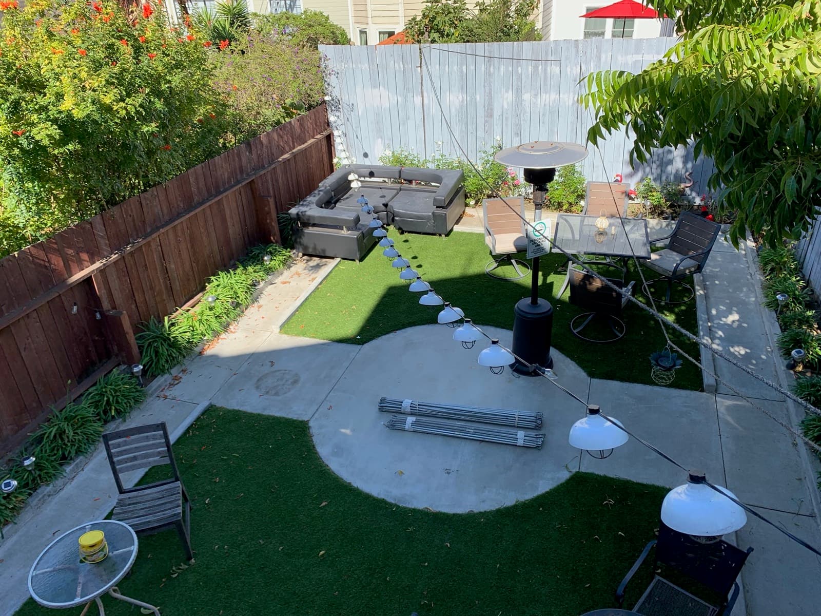 Backyard with turf, string lights and outdoor seating